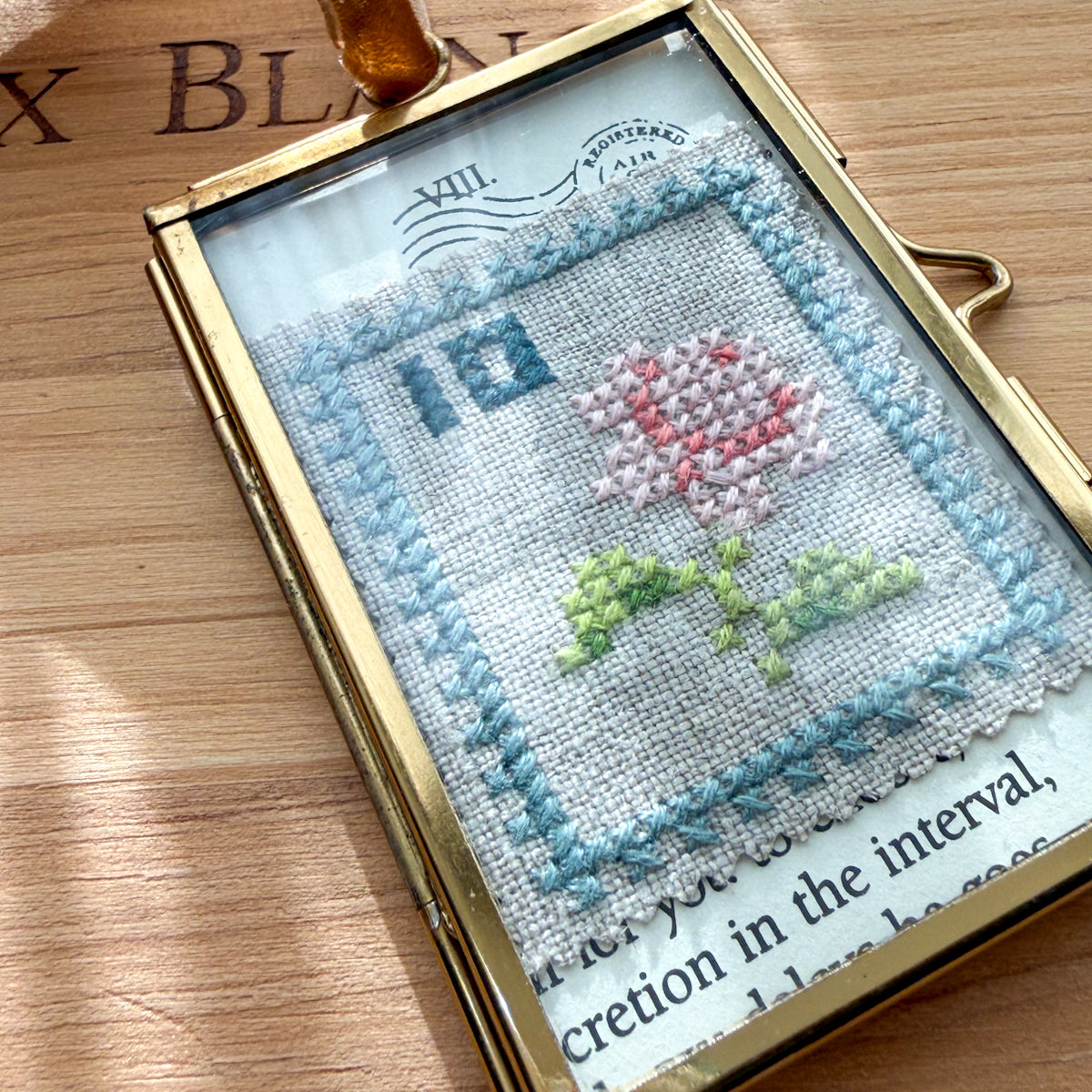 Glass-framed Cross-stitched Flower Postal Stamp Handmade by Amy Sinibaldi