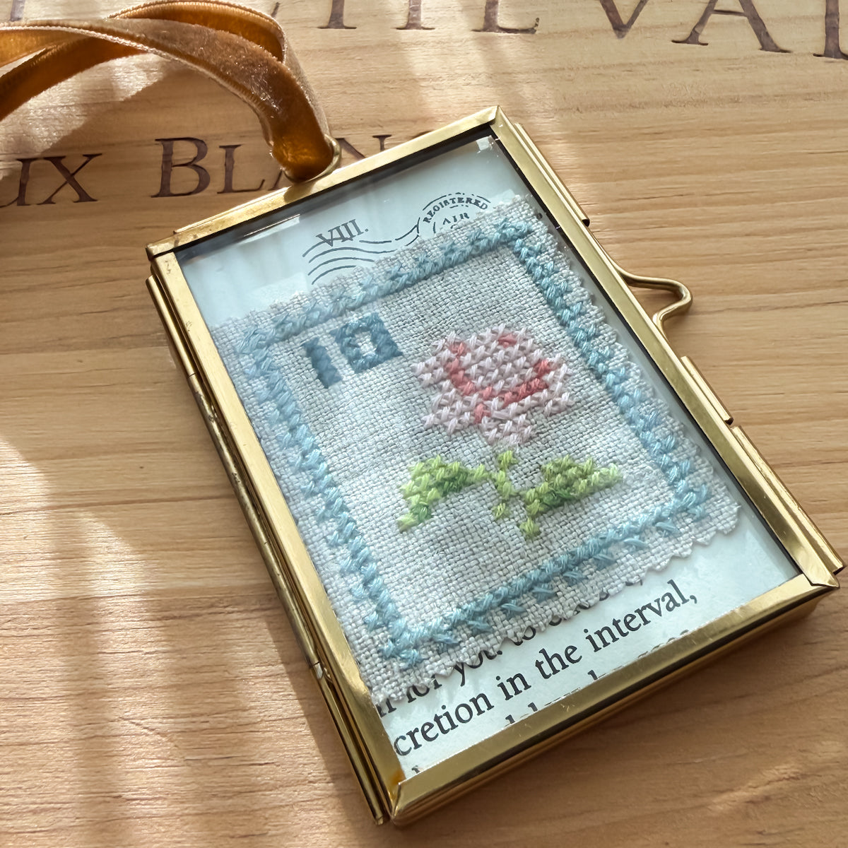 Glass-framed Cross-stitched Flower Postal Stamp Handmade by Amy Sinibaldi