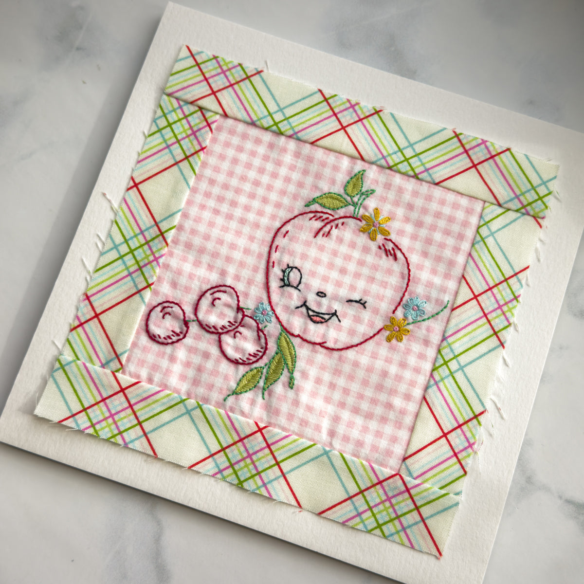 Hand embroidered Apple + Berries Quilt Block made by Amy Sinibaldi