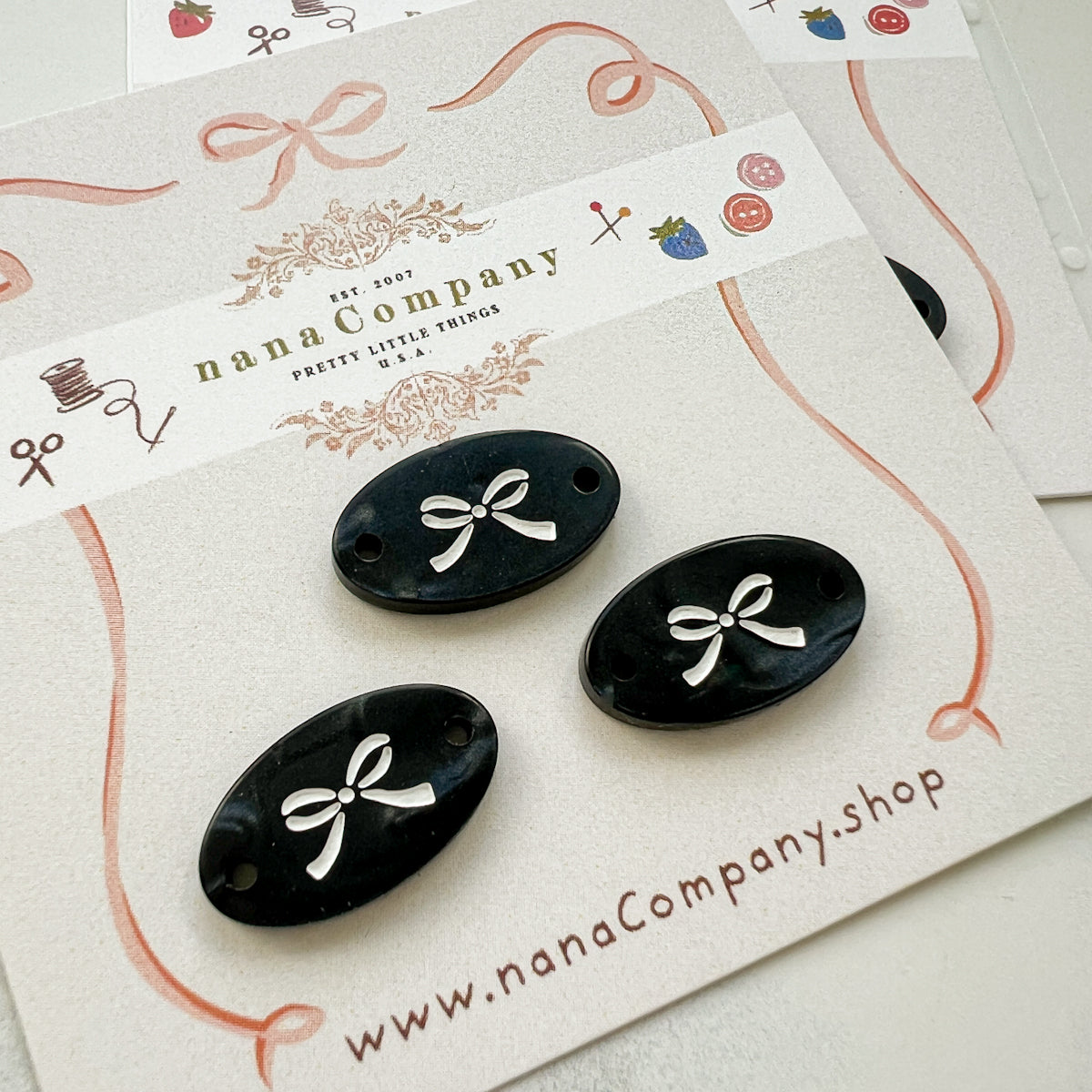 White bow on Black Oval buttons embellishments